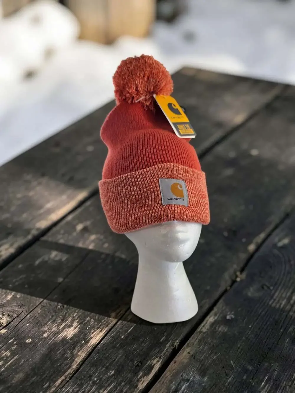 Carhartt Women's Lookout Pom Cuffed Knit Beanie Hat in Rust Orange